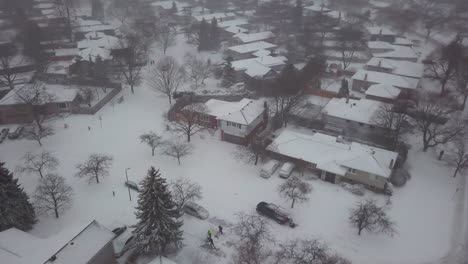 Aerial-drone-view-of-a-snow-covered-residential-neighbourhood-on-a-cold,-winter-day