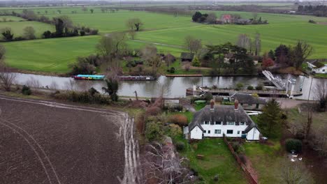 Baits-bite-lock-river-Cam-Cambridgeshire-UK-aerial-drone-footage-,-narrow-boats-waiting-to-pass-through
