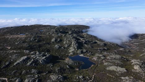 Aerial-view-orbiting-around-a-beautiful-cloud-coming-into-the-mountain-at-Serra-da-Estrela-Portugal