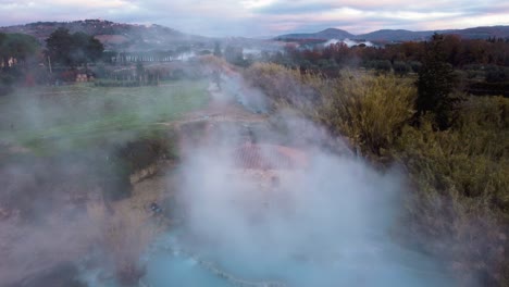 The-geothermal-thermal-hot-springs-bath-and-waterfall-at-Saturnia,-Tuscany-Italy-close-to-Siena-and-Grosseto-by-sunrise