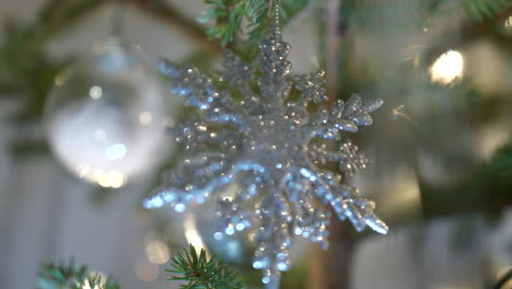 Close-up-focus-shift-between-sparkling-ornaments-in-christmas-tree