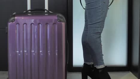 girl-coming-home-with-case-travel-Business-woman-entering-rich-home-with-suitcase