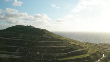 AERIAL:-Hill-with-Paddy-Fields-with-View-to-Mediterranean-Sea-During-Winter-in-Malta