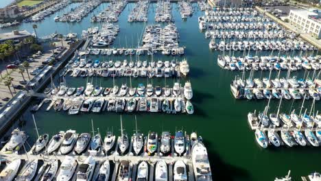 Drone-shot-flying-over-moored-yachts-and-boats-in-King-Harbor-Marina,-California