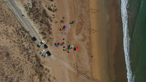 Aerial-Top-Down-View-Of-Parked-Vehicles-And-Tents-On-Beach-At-Balochistan