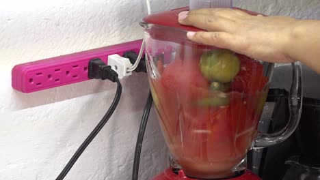 Tomatoes-inside-a-blender-to-cook-salsa