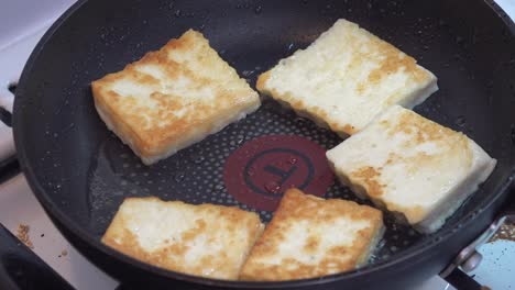 Pieces-of-cheese-frying-on-a-pan