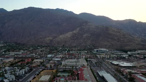 Drone-shot-of-Palm-Springs-City-and-mountains-at-sunset-in-California