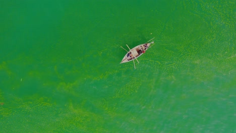 Aerial-View-Of-Fisherman-In-Traditional-Wooden-Row-Boat-In-Arabian-Sea