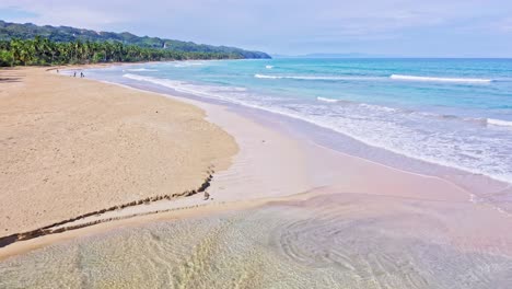 Estuary-Mouth-Meet-The-Waves-In-Shoreline-Of-Playa-Coson-Beach-In-Summer-In-Las-Terrenas,-Dominican-Republic