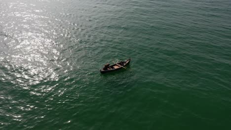 Aerial-View-Of-Traditional-Wooden-Row-Boat-In-Arabian-Sea