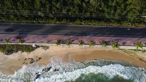 Aerial-top-down,-cars-driving-on-road-by-tropical-beach-coast