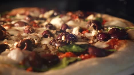 Homemade-combination-pizza-baking-in-the-oven---sliding-close-up-side-view