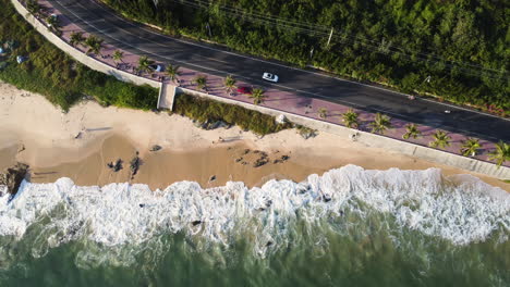 Coastal-road,-sandy-beach-and-ocean-waves-hitting-shoreline---holiday-getaway,-aerial-top-down-view