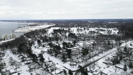 Fast-pan-with-drone-over-snow-covered-beach-neighborhood