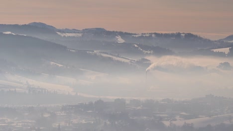 Slow-pan-over-pollution-covered-village-in-winter-valley