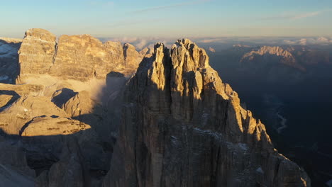 Cinematic-drone-shot-of-Tre-Cime-di-Lavaredo-in-Italy,-moving-closer-to-peak-with-slow-rotation