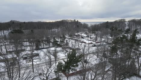 Gimbal-tilt-while-rising-over-a-Lakeshore-Neighborhood-in-Michigan-during-a-soft-snowfall