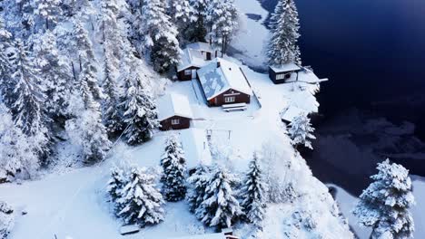 Aerial-View-Of-Snowy-Cabin-And-Forest-At-Wintertime-In-Norway