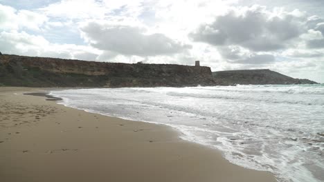 Golden-Bay-near-Rocky-Hills-with-Mediterranean-Sea-Washing-Sandy-Beach