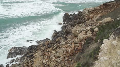 Big-Mediterranean-Sea-Waves-Crashes-on-Limestones-on-Golden-Beach-Bay-Shore-in-Winter