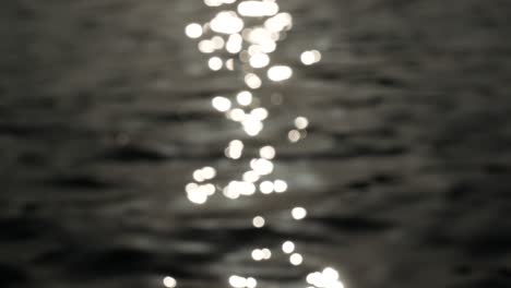 Blurred-reflection-on-rippled-water,-wavy-liquid-surface-reflecting-light,-abstract-nature-background