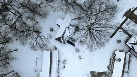 Drone-descending-over-a-snowy-neighborhood-in-January-2022