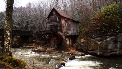 Grist-Mill-in-West-Virginia-with-river-flowing-and-snow-falling