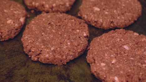 Plant-based-Impossible-Burger-meat-patties-on-pan-un-cooked-waiting-to-be-prepared-and-cooked---in-Cinema-4k-