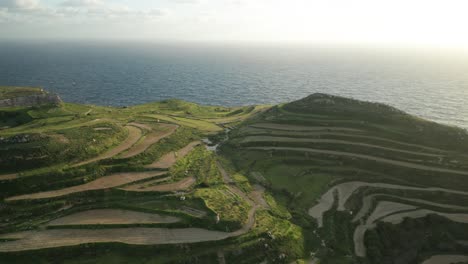 AERIAL:-Flying-Above-Cliffs-Towards-Mediterranean-Sea-in-Malta-during-Sunset-Golden-Hour