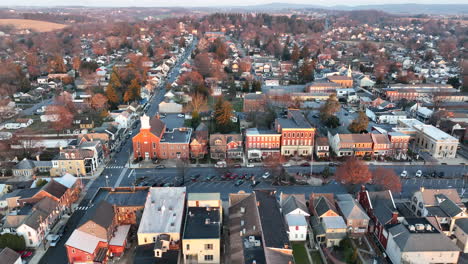 High-aerial-truck-shot-of-small-town-America-during-golden-hour