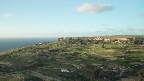 AERIAL:-Green-High-Rugged-Cliffs-Overseeing-Mediterranean-Sea-Washing-Coastline-in-Malta