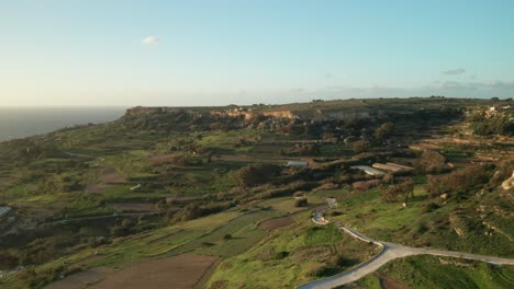 AERIAL:-Green-Farmlands-Rugged-with-Roads-and-Rocky-Surface-near-Mediterranean-Sea