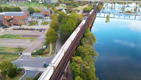 Train-Traveling-on-Scenic-Riverfront-in-Richmond,-Virginia-|-Aerial-View-Panning-Across-|-Summer-2021