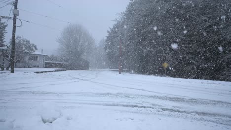 Heavy-Snowfall-on-a-turn-of-a-Road-in-a-Small-Town