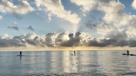 iPhone-13-cinematic-video-of-Paddleboarders-on-the-Atlantic-Ocean-along-Hollywood-Beach,-Florida-during-morning-sunrise