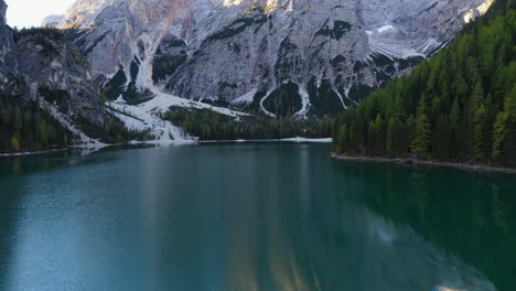Filmische-Drohnenaufnahme,-Die-Auf-Dem-Smaragdfarbenen-Wasser-Beginnt-Und-Sich-Dann-Zum-Wunderschönen-Lago-Di-Braies,-Italienischen-Dolomiten,-In-Südtirol,-Italien,-Neigt