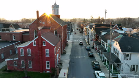 Aerial-establishing-shot-of-small-town-USA-at-sunrise