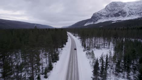Driving-through-a-mountain-valley-during-winter