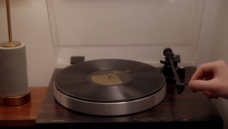 A-person-putting-on-a-vinyl-record-to-listen