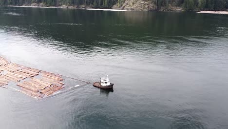 Tug-Boat-Pulling-Logs-in-the-Pacific-Ocean,-Port-Alberni,-Vancouver-Island,-Canada