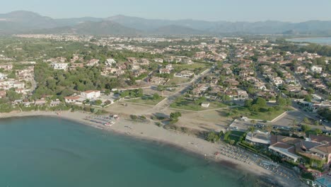 Aerial-panoramic-view-of-Arbatax-east-sardinia-coastline,-drone-fly-above-the-city-revealing-the-natural-landscape-of-italian-island