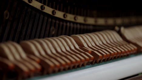 Piano-hammers-hitting-the-strings-of-the-piano-in-slow-motion