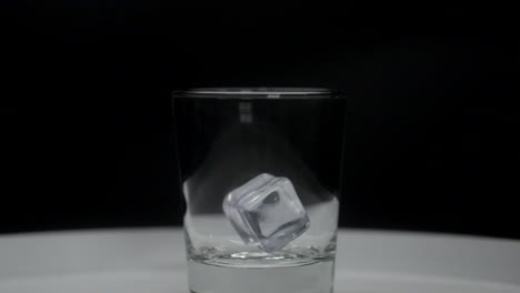 Ice-cubes-slowly-falling-into-scotch-glass