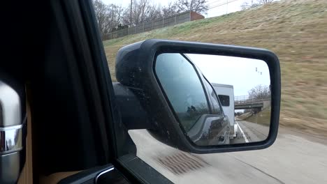 Hauling-a-horse-trailer-on-a-freeway-in-Southeast-Michigan-view-through-a-side-rearview-mirror---4k