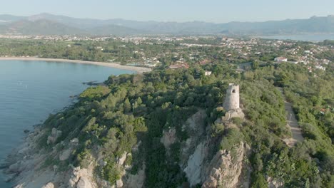 Aerial-view-of-San-gemiliano-tower-old-stone-castle-fortress-on-east-coastline-of-Sardinia,-Italy
