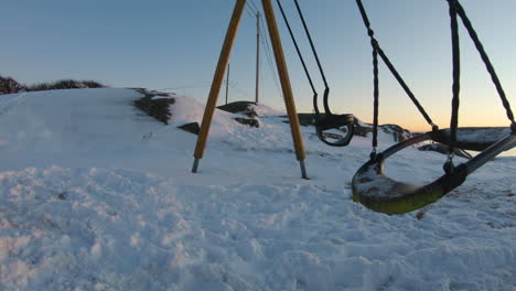 4k-Close-up-of-a-swing-on-a-playground-on-a-cold-winter-day-in-Sweden