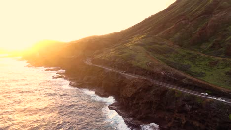 Drohnenaufnahme-Des-Hawaiianischen-Highways-Auf-Einer-Klippe-Neben-Dem-Meer-Bei-Sonnenaufgang