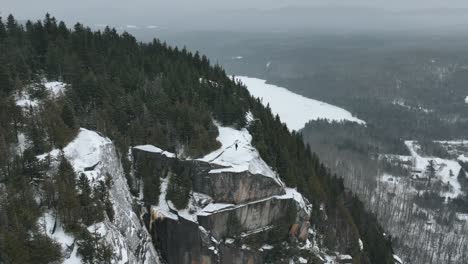 Man-Isolated-On-Top-Of-Rugged-Cliffs-During-Winter-In-Quebec,-Canada