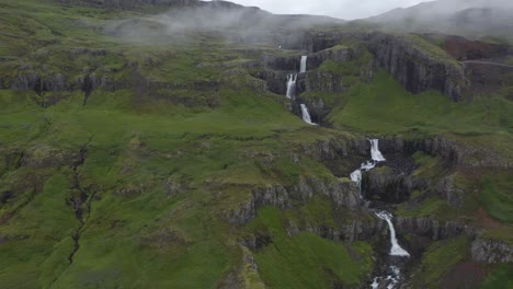 Aerial-trucking-shot-of-a-series-of-small-waterfalls-named-Klifbrekkufossar-in-Iceland